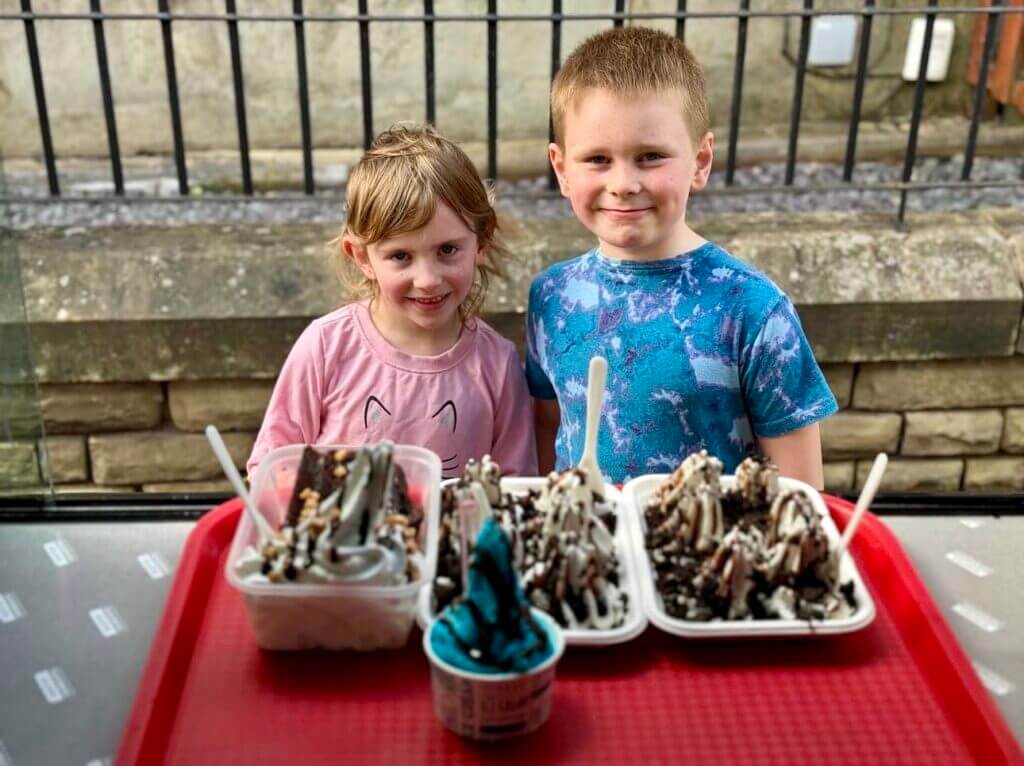 Children smiling with their served order of Tasty Twirl Treat Tray Ice-Cream