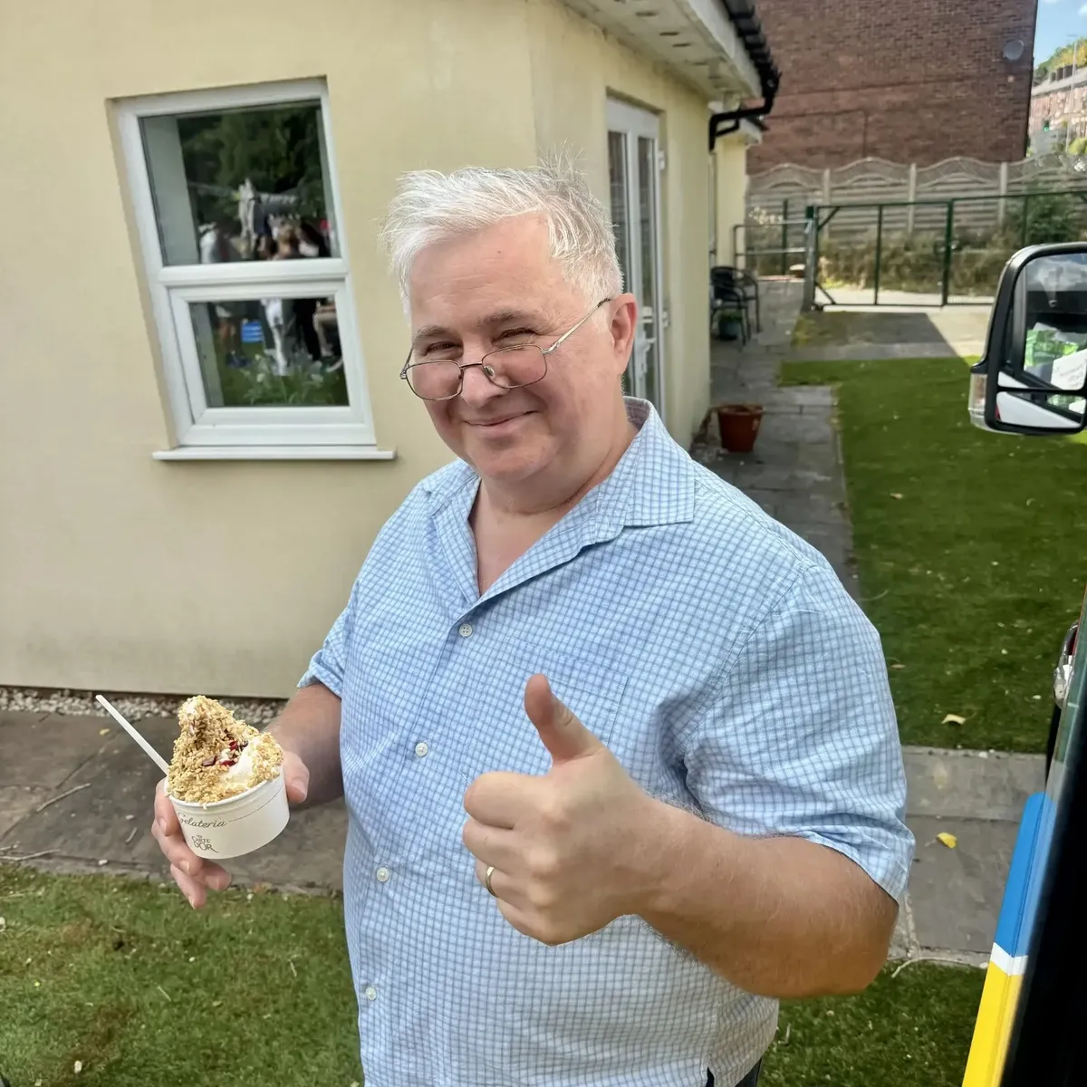 Shez Whippy serving ice cream on Holly Bank Nursing Home Community event in Radcliffe