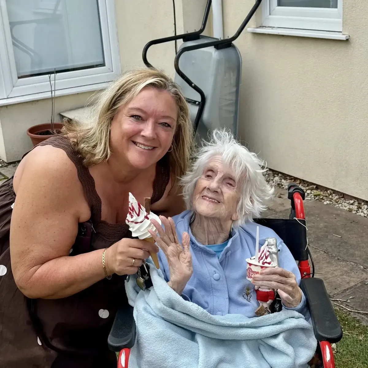 Shez Whippy serving ice cream to elderly on Holly Bank Nursing Home Community event in Radcliffe