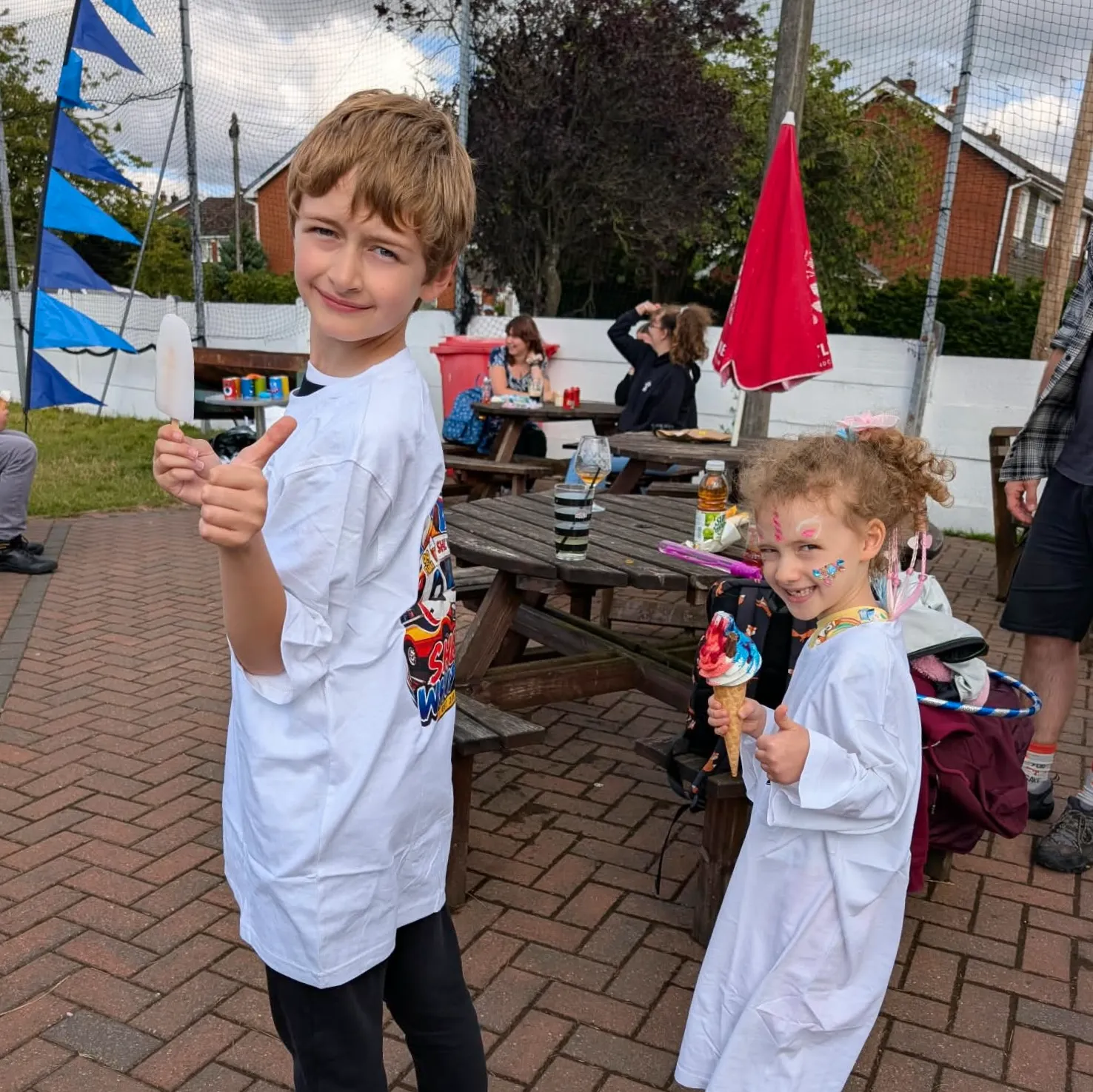 Shez Whippy serving ice cream to children on family fun day private event in Bury