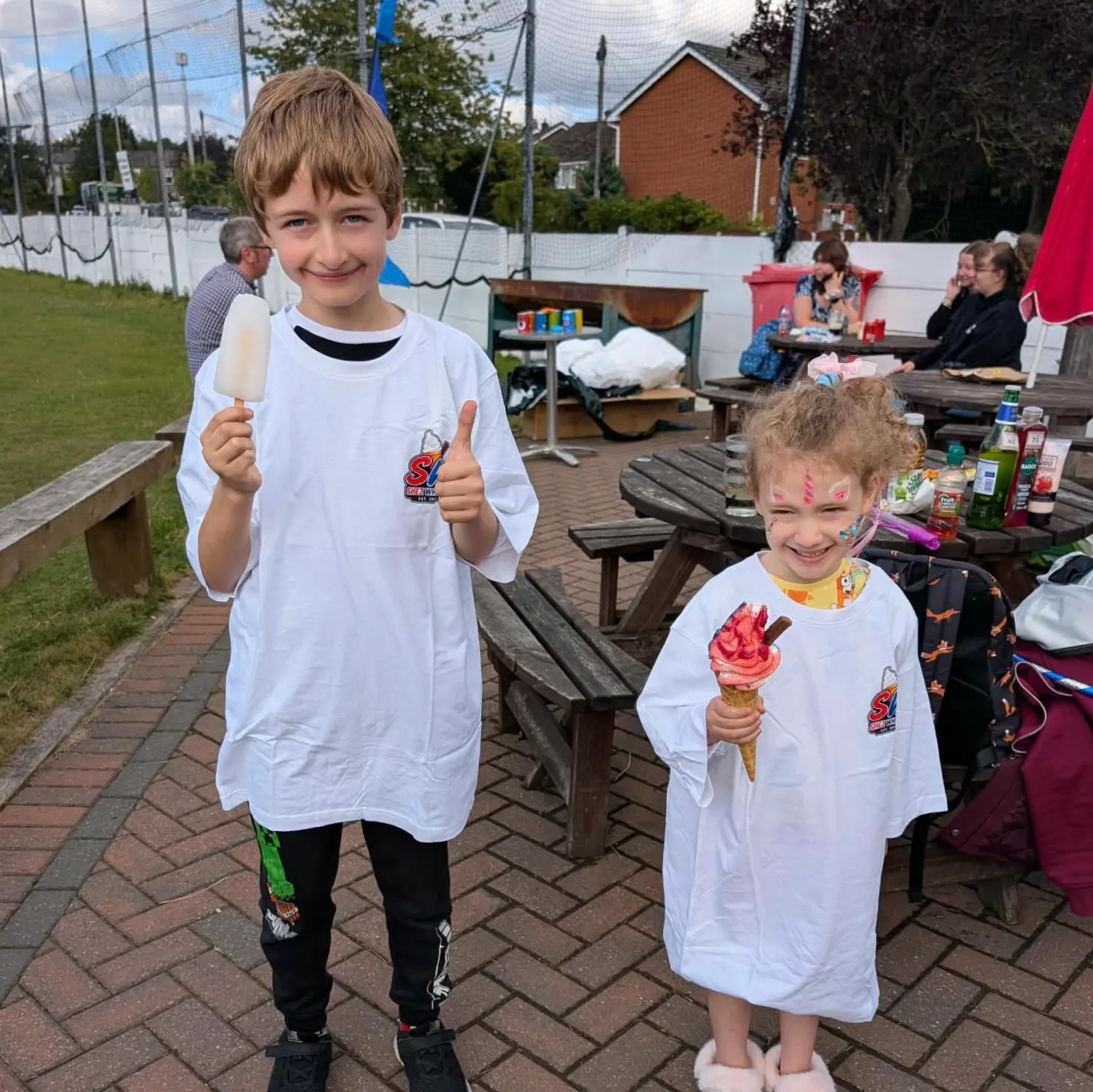 Shez Whippy serving ice cream to children on family fun day private event in Bury