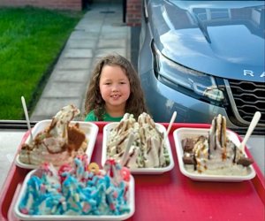 a child similing with her served 4 ice cream trays by shez whippy on the streets of manchester