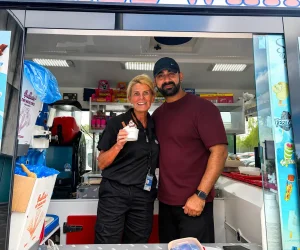Mr Shez and customer taking a photo inside Shez Whippy Van on a community event in Greater Manchester